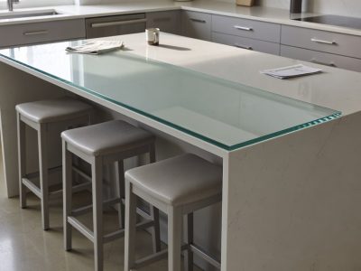 Toughened glass breakfast bar top cut to size, laid flush on a wooden worktop