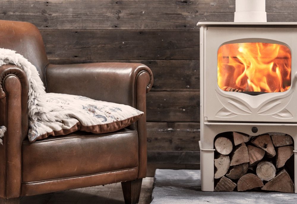 Charnwood Bembridge wood-burning stove with heat-resistant glass ceramic door panel, fire on.