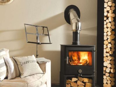 Chilli Penguin 8 wood-burning stove with heat-resistant glass ceramic landscape door panel, fire on.