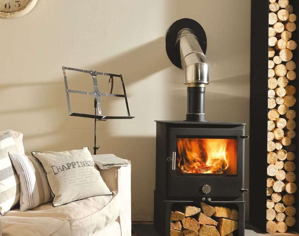 Chilli Penguin 8 wood-burning stove with heat-resistant glass ceramic landscape door panel, fire on.