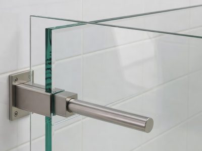 Frameless toughened wet room glass panel cut to size, wall fixed with a slim support bar